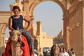 The boy on a camel in antique city of Palmyra in Syria