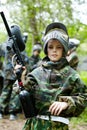 Boy in camouflage suit holds a paintball gun Royalty Free Stock Photo