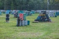 Boy in camouflage suit stands on the paintball field with his paintball gun up and looks straight ahead. team work, sport Royalty Free Stock Photo