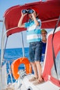 Boy captain with his sister on board of sailing yacht on summer cruise. Travel adventure, yachting with child on family Royalty Free Stock Photo