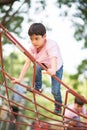 A boy Carefully climb up the rope bridge Royalty Free Stock Photo