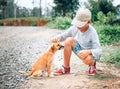 Boy caresses little homeless puppy Royalty Free Stock Photo