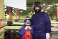 Boy and carting trainer are standing in helmets