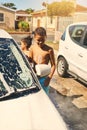 Boy, carwash and vehicle in home, soap and driveway with help of family. Child siblings, bonding or duty for cleaning Royalty Free Stock Photo