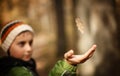 Boy catching a falling leaf