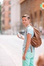 Boy caucasian with smartphone walking in street at Europe Royalty Free Stock Photo