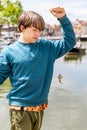 The boy caught a goby fish on a canal in Amsterdam Royalty Free Stock Photo