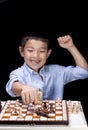 Boy celebrates chess win. Royalty Free Stock Photo
