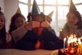 Boy Celebrating Birthday With Group Of Friends At Home Being Given Cake Decorated With Sparkler Royalty Free Stock Photo