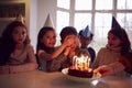 Boy Celebrating Birthday With Group Of Friends At Home Being Given Cake Decorated With Sparkler Royalty Free Stock Photo