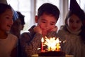 Boy Celebrating Birthday With Group Of Friends At Home Being Given Cake Decorated With Sparkler Royalty Free Stock Photo