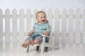 Boy in chair with fence Royalty Free Stock Photo