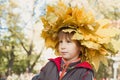 Boy with chaplet of yellow maple leaves