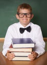 Boy child, happy and portrait with books, classroom and learning for exam, assessment and studying for knowledge Royalty Free Stock Photo