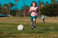 Boy child kicking football on the sports field during soccer match. Child soccer football.