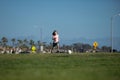 Boy child kicking football on the sports field during soccer match. Kids play soccer game.