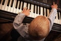 Boy child kid playing on digital keyboard piano synthesizer Royalty Free Stock Photo