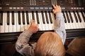 Boy child kid playing on digital keyboard piano synthesizer Royalty Free Stock Photo