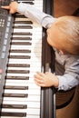 Boy child kid playing on digital keyboard piano synthesizer Royalty Free Stock Photo