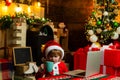 Boy child with laptop near christmas tree. Little boy drinking hot tea or cacao. Happy family holidays. Christmas