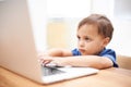 Boy child, laptop and typing in home, reading or search for movie, cartoon or elearning for development. Kid, computer Royalty Free Stock Photo