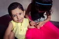 boy child looking at camera excitingly while sitting with her si Royalty Free Stock Photo