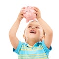 Boy child, piggy bank and happy in studio with thinking, money and savings by white background. Kid, box or animal toy