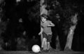 Boy child playing football on football field. Kid playing soccer. Child soccer player in park. Royalty Free Stock Photo