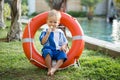 Boy child playing with lifebuoy. Baby care and childhood concept