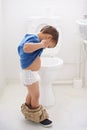 Boy child, potty training and toilet with thinking, diaper and pants on floor for learning, development and progress Royalty Free Stock Photo