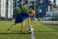 Boy child putting ball on strip line on football field, start game match