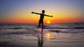 Boy child is running out of water on a sea beach at sunset Royalty Free Stock Photo