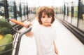 Boy child with shopping trolley with products. Little cute boy with shopping cart full of fresh organic vegetables and Royalty Free Stock Photo