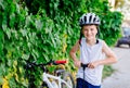 Boy child in white bicycle helmet inflating tire Royalty Free Stock Photo