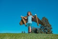 Boy child with wings at sky imagines a pilot and dreams of flying. Royalty Free Stock Photo