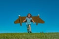 Boy child with wings at sky imagines a pilot and dreams of flying. Royalty Free Stock Photo