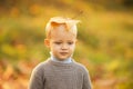 Boy child with yellow leaf in autumn park. Happy child dreams outdoors in autumn. Dreaming kids.