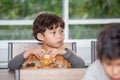 boy Children enjoy eating pizza in classroom school . kid hungry Royalty Free Stock Photo