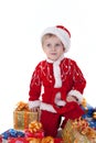 Boy in christmas clothes with toys