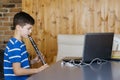 Boy with a clarinet plays music. Online music lesson concept