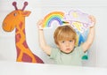 Boy in the class show weather cards with rain and rainbow Royalty Free Stock Photo