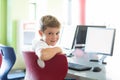 Boy with classmates and teacher in computer room Royalty Free Stock Photo