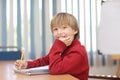 Boy in classroom learning and in concertrated moment