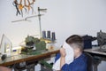 Boy is cleaning face after a haircut at home in home sewing room Royalty Free Stock Photo