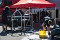 Boy cleaning slick racing tires with a sponge, soap and water