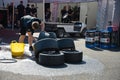 A boy cleaning slick racing tires with a sponge Royalty Free Stock Photo