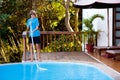 Boy cleaning swimming pool. Maintenance, service Royalty Free Stock Photo