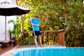 Boy cleaning swimming pool. Maintenance, service Royalty Free Stock Photo