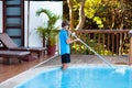 Boy cleaning swimming pool. Maintenance, service Royalty Free Stock Photo