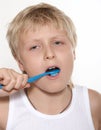 The boy cleans a teeth a tooth-brush. A background white